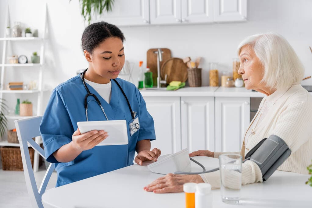 A care professional reviewing a patient's blood pressure