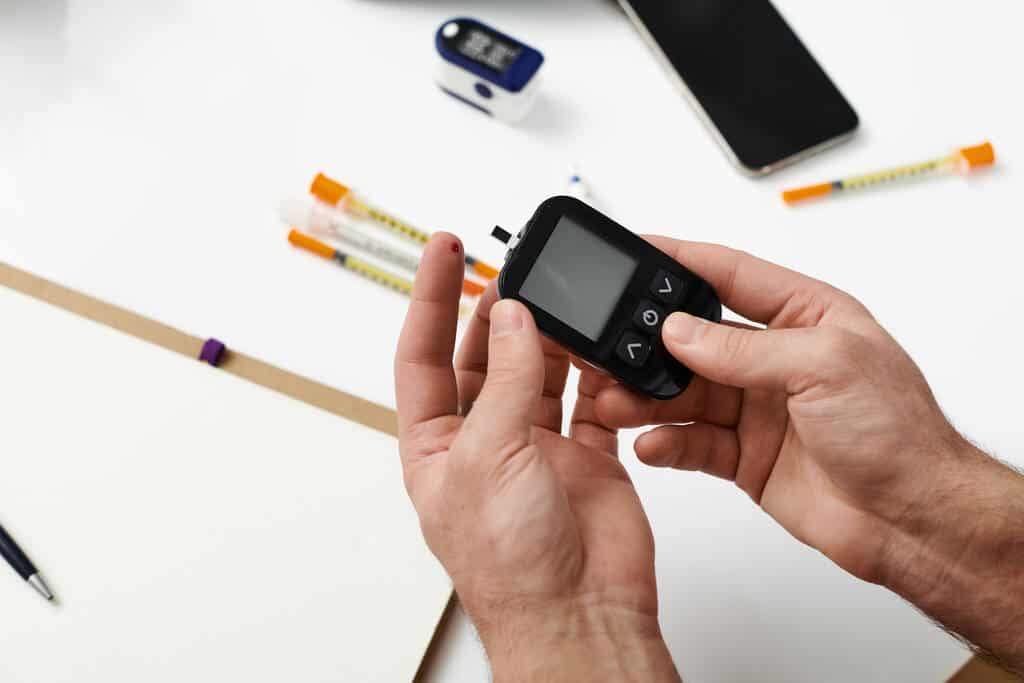 A patient checking blood glucose at home
